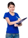 Young lady take note on clipboard Royalty Free Stock Photo