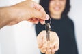 Young lady taking keys from female real estate agent during meeting after signing rental lease contract Royalty Free Stock Photo