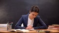 Young lady teacher checking schoolchildrens assignments, occupation, paperwork