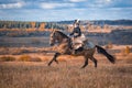 Young lady in 19th century dress riding a akhal teke horse Royalty Free Stock Photo