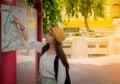 Asian Young lady tourist using map in the road looking somewhere Royalty Free Stock Photo