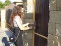 Young lady unlocks the door of the house