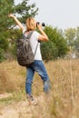 Young lady walking on a rural road with digital camera Royalty Free Stock Photo