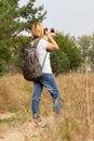 Young lady walking on a rural road with digital camera Royalty Free Stock Photo