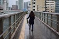 Lady walking in the rainy city of Tokyo, Japan