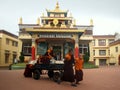 Young buddhist monks pulling a trolley