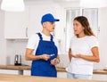 Young landlady explains her problem to a guy plumber