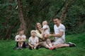 Young large family have a picnic outdoor. Mother father and three children. Happy family