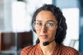 A young Latin American woman in a headset. Call center, service operator, hotline, support line Royalty Free Stock Photo