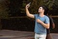 Young latin man making a videocalling in the city. Royalty Free Stock Photo