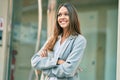 Young latin businesswoman with crossed arms smiling happy at the city