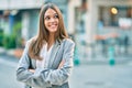 Young latin businesswoman with crossed arms smiling happy at the city