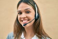 Young latin call center aget girl smiling happy using headset at the city Royalty Free Stock Photo