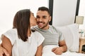 Young latin couple kissing and hugging on the bed at home Royalty Free Stock Photo