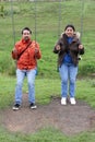 Young Latin couple of man and woman walk in the park sharing quality time playing frisbee and flying a kite outdoors doing sports Royalty Free Stock Photo