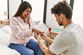 Young latin couple on marriage proposal at the bedroom Royalty Free Stock Photo