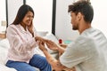 Young latin couple on marriage proposal at the bedroom Royalty Free Stock Photo