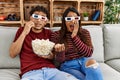 Young latin couple scared watching movie using 3d glasses at home Royalty Free Stock Photo