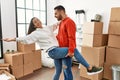 Young latin couple smiling happy dancing at new home Royalty Free Stock Photo