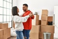 Young latin couple smiling happy dancing at new home Royalty Free Stock Photo