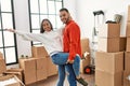 Young latin couple smiling happy dancing at new home Royalty Free Stock Photo