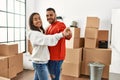Young latin couple smiling happy dancing at new home Royalty Free Stock Photo