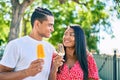 Young latin couple smiling happy eating ice cream at the park Royalty Free Stock Photo