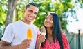 Young latin couple smiling happy eating ice cream at the park Royalty Free Stock Photo