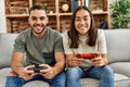 Young latin couple smiling happy playing video game at home Royalty Free Stock Photo