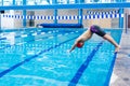 Young latin disabled sportsman jumping in the pool During A swimming training with hand hypoplasia in disability concept in Latin Royalty Free Stock Photo