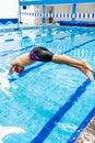 Young latin disabled sportsman jumping in the pool During A swimming training with hand hypoplasia in disability concept in Latin Royalty Free Stock Photo