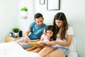 Parents reading to their kid before sleeping Royalty Free Stock Photo