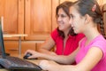 Young latin girl and her mother working on a computer Royalty Free Stock Photo