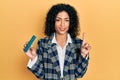 Young latin girl holding computer ram smiling with an idea or question pointing finger with happy face, number one Royalty Free Stock Photo