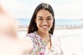 Young latin girl smiling happy making selfie by the camera at the beach Royalty Free Stock Photo