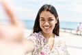Young latin girl smiling happy making selfie by the camera at the beach Royalty Free Stock Photo