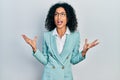 Young latin girl wearing business clothes and glasses crazy and mad shouting and yelling with aggressive expression and arms Royalty Free Stock Photo