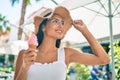 Young latin girl wearing summer style eating ice cream at street of city Royalty Free Stock Photo