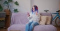 Young latin hispanic teenager blogger girl making video call at home. Cozy home interior with indoor plants. Remote work