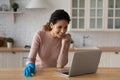 Housewife distracted from housekeeping use laptop enjoy videoconference event Royalty Free Stock Photo