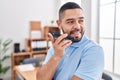 Young latin man business worker smiling confident talking on smartphone at office Royalty Free Stock Photo