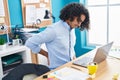 Young latin man business worker suffering for backache working at office Royalty Free Stock Photo