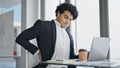 Young latin man business worker using laptop suffering for backache at office Royalty Free Stock Photo