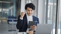 Young latin man business worker using touchpad with winner gesture at office Royalty Free Stock Photo