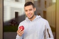 Young latin man eating apple fruit runner winter running sports training fitness Royalty Free Stock Photo