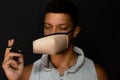 Young latin man with a gesture of relief when removing his face mask Royalty Free Stock Photo