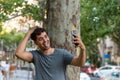 Young latin man making a videocalling in the city. Royalty Free Stock Photo