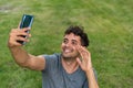 Young latin man making a videocalling in the park. Royalty Free Stock Photo