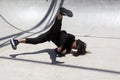 Latin man performing street dance inside skating pit