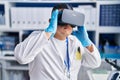 Young latin man scientist using virtual reality glasses at laboratory Royalty Free Stock Photo